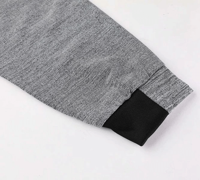 Close-up of a grey sweatshirt sleeve with black cuff, highlighting the durable fabric of a men's casual solid color zip hoodie.